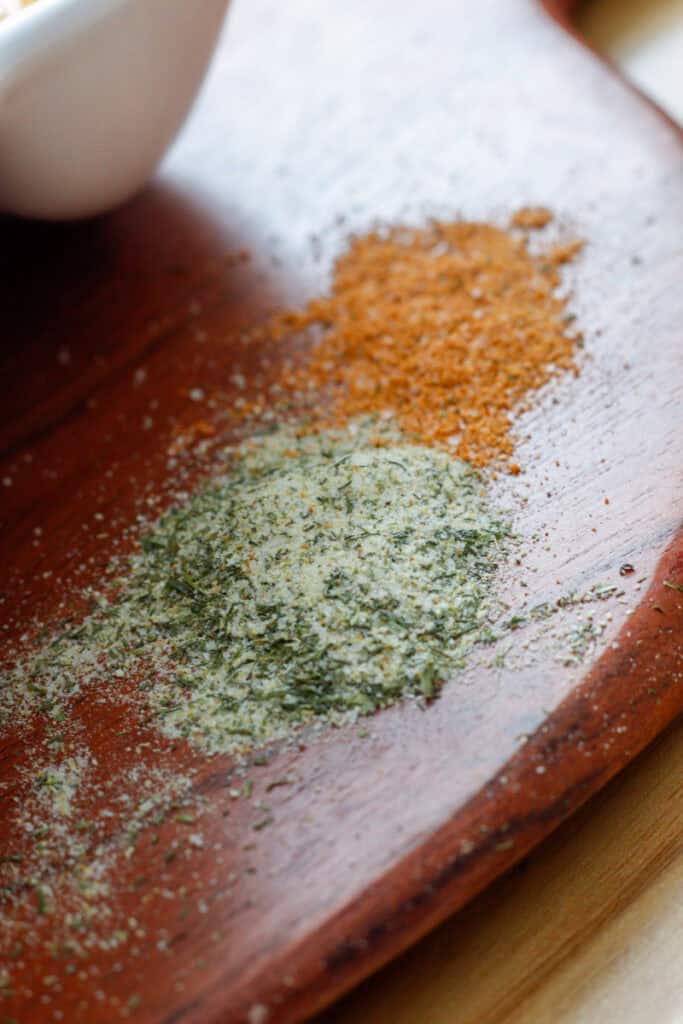 Seasoning sprinkled on a brown cutting board