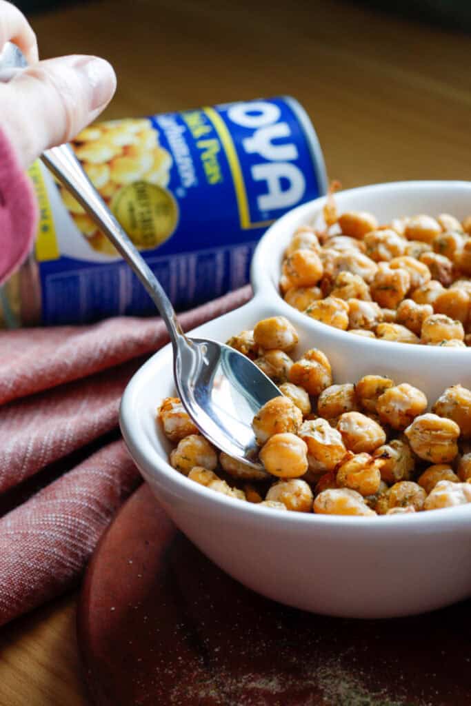 Hand spooning chickpea snack out of bowl