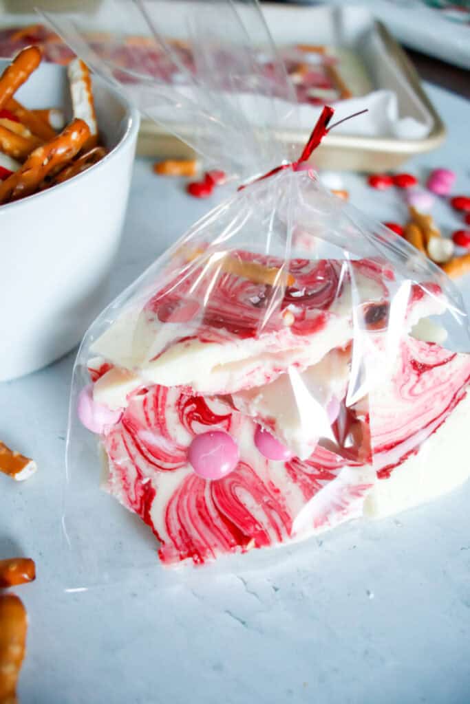 White chocolate valentine's candy packaged for gifting with a red ribbon