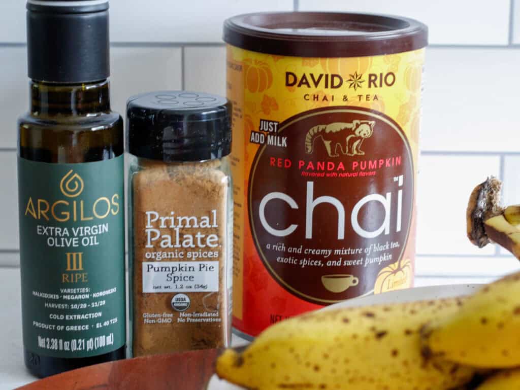 Close up of Argilos olive oil, Primal Palate pumpkin pie spice and David Rio Chai tea mix.