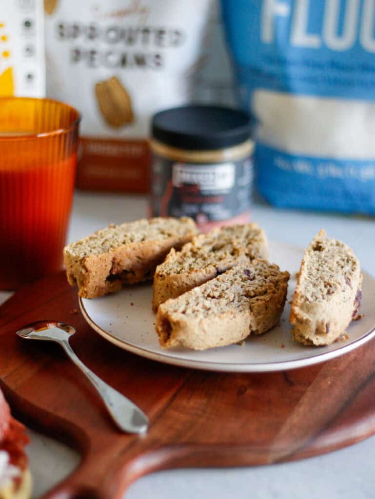 Warm homemade chocolate chip cookies with a rustic appearance on a white plate, surrounded by snacks, creating a cozy and inviting breakfast or snack scene.