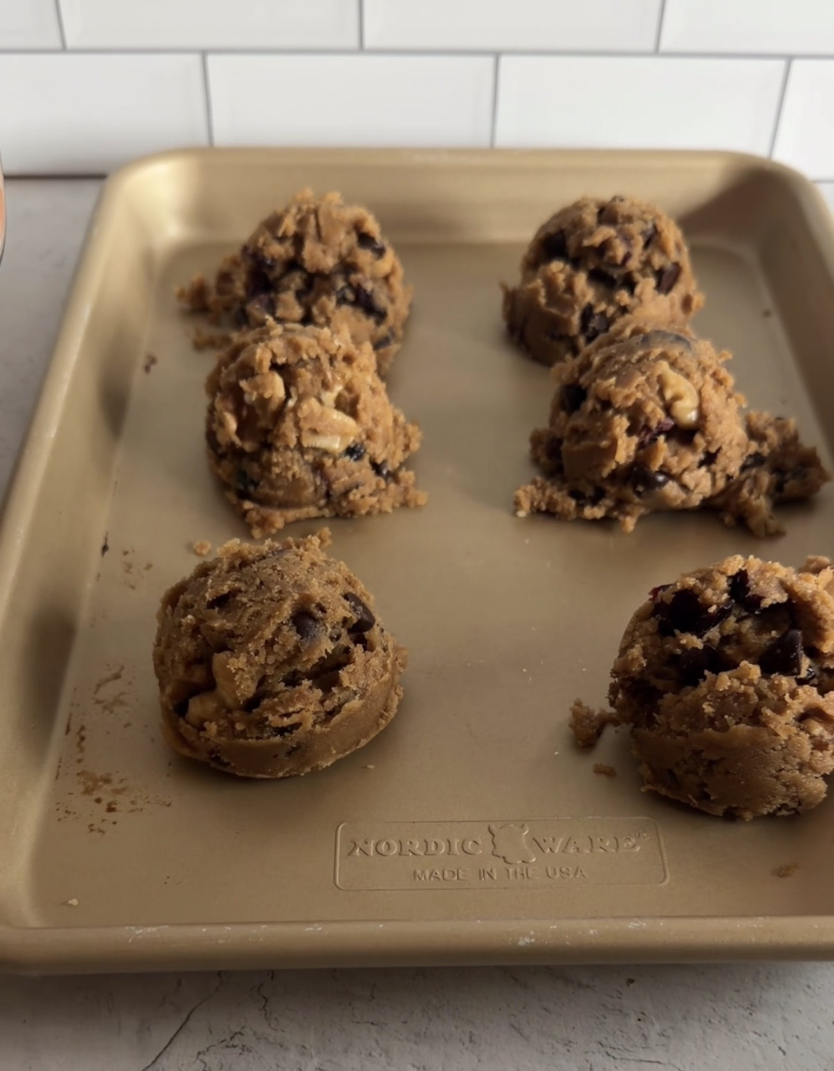 cookie dough balls on a baking sheet for chewy pumpkin cookies
