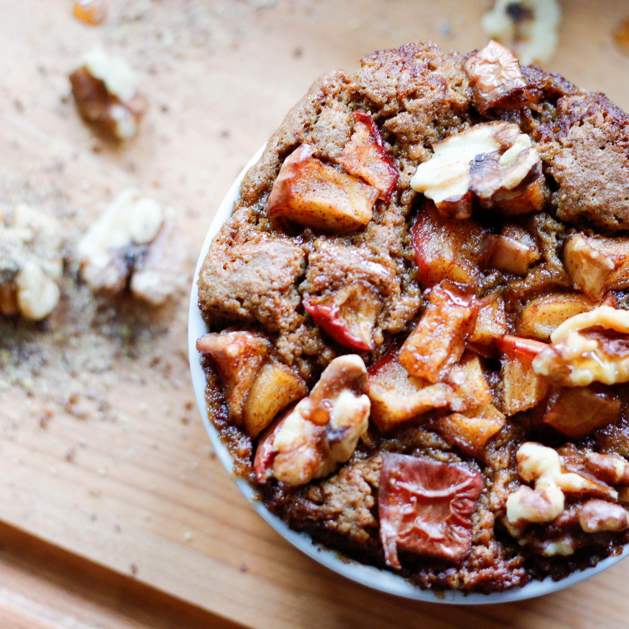 Apple Chunks baked into pumpkin bread in a small mug overhead.