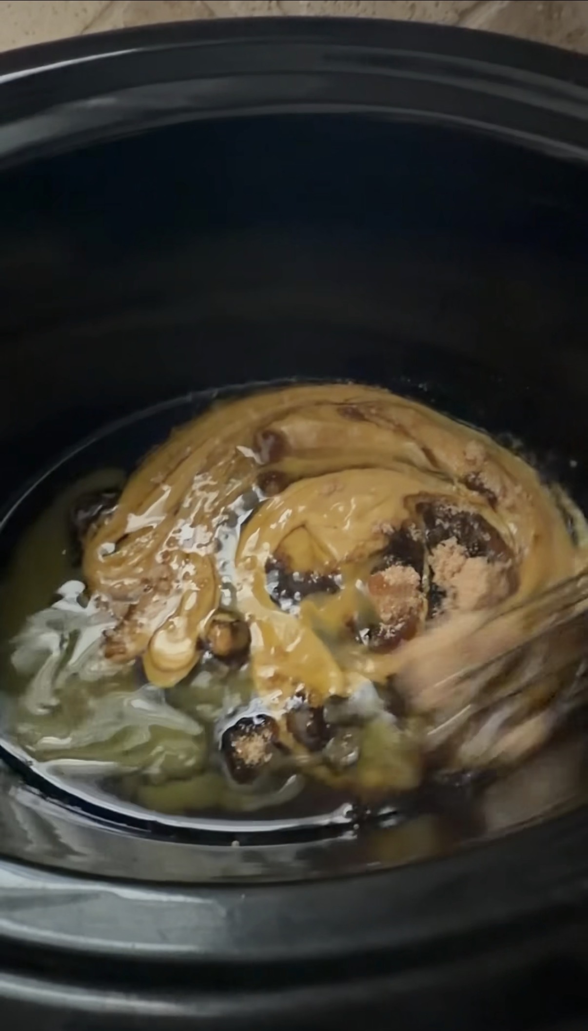 mixing together sauce ingredients in slow cooker