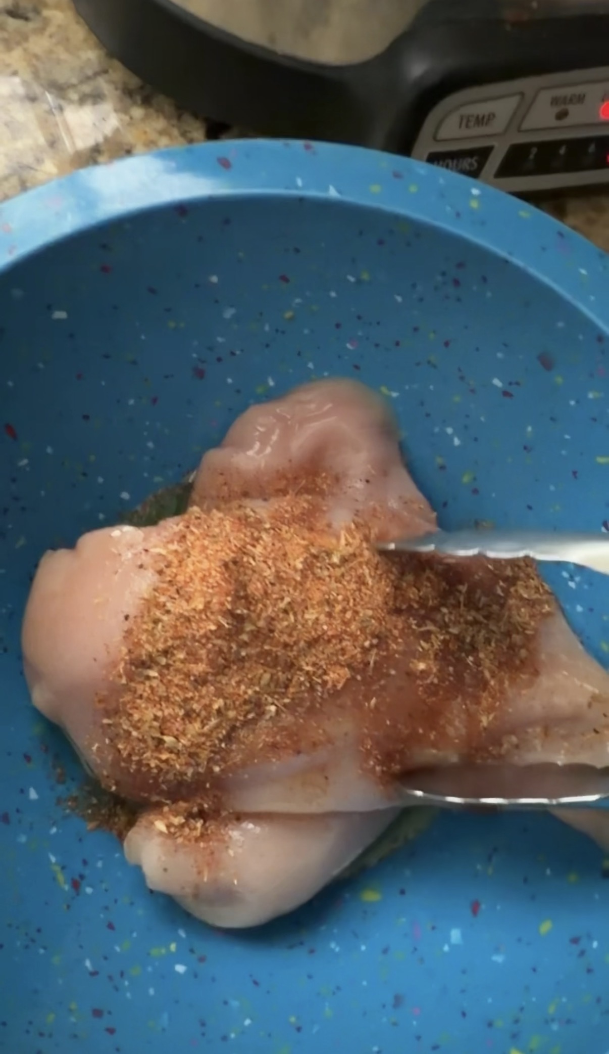 seasoning chicken in bowl
