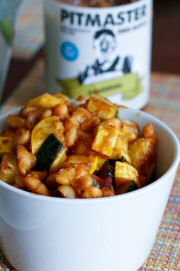 BBQ white beans and squash in a white serving dish
